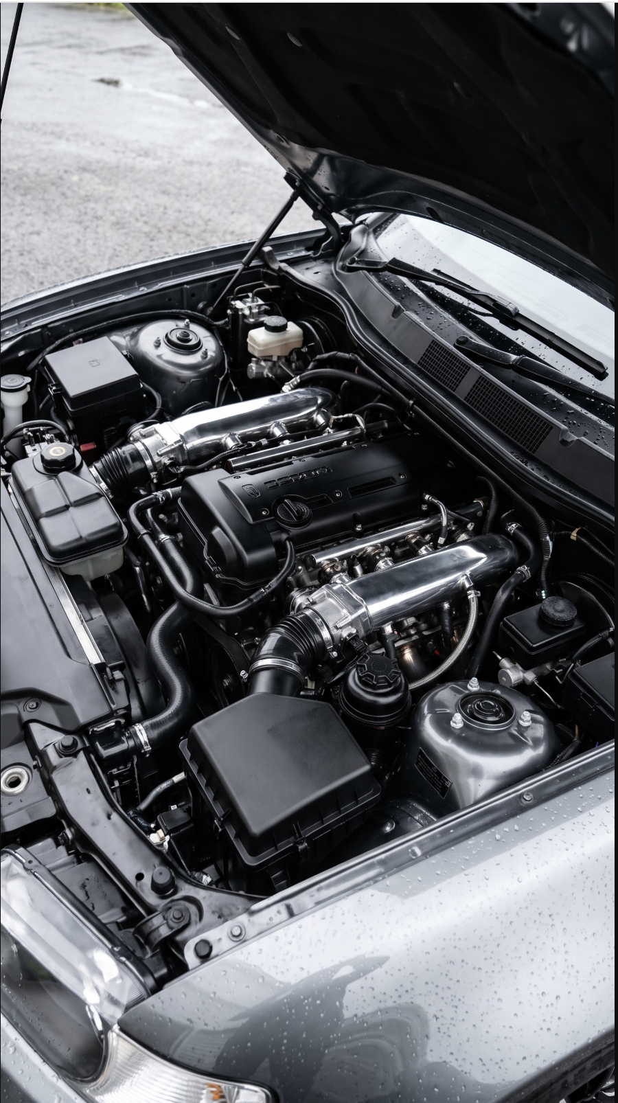Detailed metallic BMW engine bay after cleaning and dressing